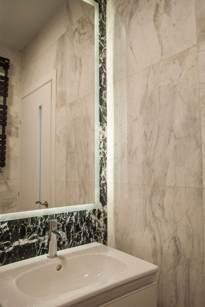 regula 70 30 design interior intr-o baie cu marmura alba si neagra lavoar alb si oglinda 
